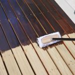 when to stain a new deck